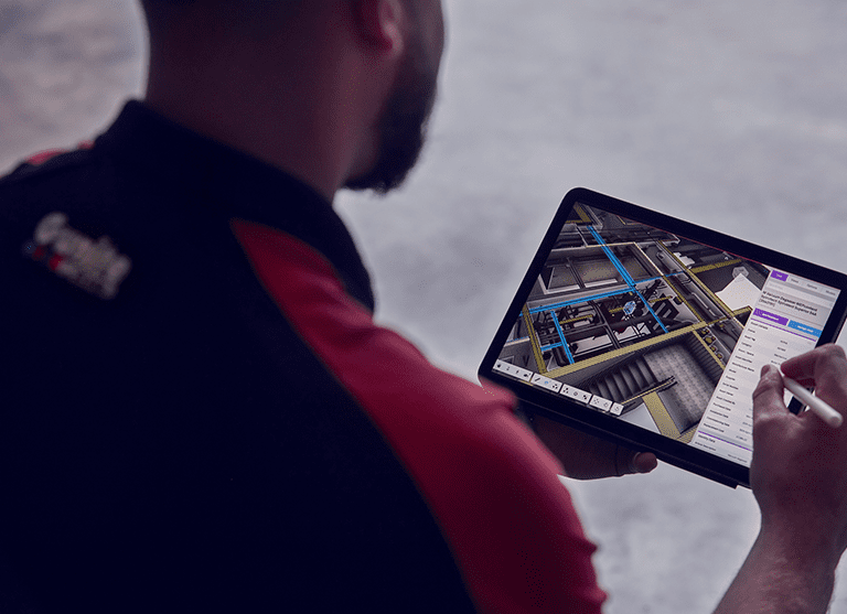 Virtuscan employee using tablet to examine 3D model and scanning aerial shot.
